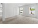 Bright, empty bedroom with neutral carpet, a closet, and two windows, ready for personalization at 25830 Crippen Dr, Land O Lakes, FL 34639