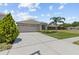 Charming single-story home featuring a well-manicured front yard and a two-car garage at 25830 Crippen Dr, Land O Lakes, FL 34639