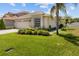 Beautiful single-story home with lush landscaping, well-manicured lawn, and attached two-car garage at 25830 Crippen Dr, Land O Lakes, FL 34639