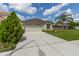 Charming home with a two-car garage, beautiful landscaping and spacious driveway at 25830 Crippen Dr, Land O Lakes, FL 34639