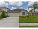 Charming single-story home with a two-car garage, landscaped yard, and neutral exterior at 25830 Crippen Dr, Land O Lakes, FL 34639