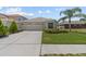 Well-maintained home with a manicured lawn, a two-car garage, and a beautiful landscape at 25830 Crippen Dr, Land O Lakes, FL 34639