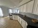 Open concept kitchen showcases granite counters, tile floors and stainless steel dishwasher at 25830 Crippen Dr, Land O Lakes, FL 34639