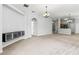 Spacious carpeted living room with elegant lighting and decorative wall art at 25830 Crippen Dr, Land O Lakes, FL 34639