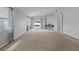 Spacious living room features lots of light, a modern design, and neutral-colored carpet at 25830 Crippen Dr, Land O Lakes, FL 34639