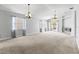 Spacious living room with neutral tones, large windows, and chandelier lighting at 25830 Crippen Dr, Land O Lakes, FL 34639