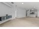Expansive living room featuring an arched doorway, neutral paint, plush carpeting and built-in shelving at 25830 Crippen Dr, Land O Lakes, FL 34639
