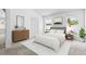 Stylishly furnished main bedroom with a plush bed, framed art and bright windows at 25830 Crippen Dr, Land O Lakes, FL 34639