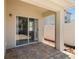 Covered patio with pavers and a sliding glass door to the interior at 25830 Crippen Dr, Land O Lakes, FL 34639