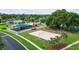 View of the playground featuring a volleyball court, play equipment and community pool in the background at 25830 Crippen Dr, Land O Lakes, FL 34639