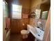 Bathroom with patterned tile, sink, toilet, and a window providing natural light at 2611 W Comanche Ave, Tampa, FL 33614