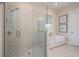 Bright primary bathroom features a glass-enclosed shower and soaking tub, complemented by neutral tile work at 20 Outlook Way Blvd # 7, Dunedin, FL 34698