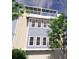 A three-story beach home showcases light blue siding and a rooftop patio with solar panels at 20 Outlook Way Blvd # 7, Dunedin, FL 34698