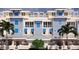 Charming exterior showcasing blue siding, white trim, and stylish architectural details with bright blue window awnings at 20 Outlook Way Blvd # 7, Dunedin, FL 34698
