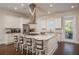 Spacious kitchen offers a marble island with seating, stainless appliances, and ample counter space at 20 Outlook Way Blvd # 7, Dunedin, FL 34698