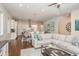 Open-concept living room featuring hardwood floors, a plush sectional sofa, and seamless flow into the dining area at 265 Causeway Blvd # 7, Dunedin, FL 34698