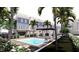 Inviting pool area complete with a pergola, lush plants and convenient parking spaces at 20 Outlook Way Blvd # 7, Dunedin, FL 34698