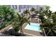 Aerial view showcasing a private pool surrounded by manicured gardens, parking, and lush tropical landscape at 265 Causeway Blvd # 7, Dunedin, FL 34698