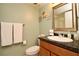 Well-lit bathroom with a modern sink, framed mirror, and tiled shower at 2700 Cove Cay Dr # 2B, Clearwater, FL 33760
