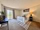 Bright bedroom features a sliding glass door and neutral decor with minimalist modern furnishings at 2700 Cove Cay Dr # 2B, Clearwater, FL 33760