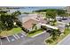 Aerial view of the clubhouse, featuring the parking lot, golf cart access, and proximity to the water at 2700 Cove Cay Dr # 2B, Clearwater, FL 33760