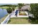 Aerial view of the clubhouse, with outdoor seating under umbrellas, a fire pit, and lush landscaping at 2700 Cove Cay Dr # 2B, Clearwater, FL 33760