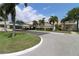 Exterior view of a well-maintained community building and lush landscaping at 2700 Cove Cay Dr # 2B, Clearwater, FL 33760