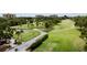 Aerial view of the golf course with lush green fairways, palm trees, and meandering pathways at 2700 Cove Cay Dr # 2B, Clearwater, FL 33760