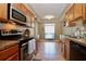 The condo kitchen features stainless appliances and oak cabinets at 2700 Cove Cay Dr # 2B, Clearwater, FL 33760