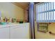 Functional bathroom featuring a walk-in shower and safety bars, ensuring convenience and safety at 2800 54Th N St, St Petersburg, FL 33710