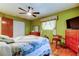 Spacious bedroom with bright green walls, a ceiling fan and wood floors, offering a cozy retreat at 2800 54Th N St, St Petersburg, FL 33710