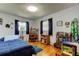 Cozy bedroom featuring a bed, desk, bookcase, and hardwood floors at 2800 54Th N St, St Petersburg, FL 33710