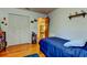 Neutral bedroom featuring a blue bedspread, closet, and wood flooring at 2800 54Th N St, St Petersburg, FL 33710