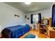 Bedroom with a bed, wood floors, desk, and natural light from the window at 2800 54Th N St, St Petersburg, FL 33710