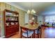 Inviting dining area with hardwood floors, vintage wallpaper, and a classic china cabinet at 2800 54Th N St, St Petersburg, FL 33710