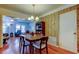 Cozy dining area with hardwood floors, vintage wallpaper, and a view into the living room at 2800 54Th N St, St Petersburg, FL 33710