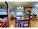Open dining area features wood floors, a vintage chandelier, and views to living area, creating an inviting space at 2800 54Th N St, St Petersburg, FL 33710