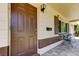 Inviting front entrance featuring a classic brown door, brick accents, and a cozy seating area at 2800 54Th N St, St Petersburg, FL 33710