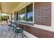 Cozy front porch showcasing a large window, brick detail, and comfortable seating for relaxation at 2800 54Th N St, St Petersburg, FL 33710