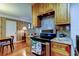 This kitchen features wood cabinets, granite countertops and stainless steel stove next to the dining area at 2800 54Th N St, St Petersburg, FL 33710