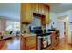 Bright kitchen with wood cabinets, stainless steel stove, granite counters, and a view of the adjacent living space at 2800 54Th N St, St Petersburg, FL 33710
