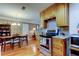 Functional kitchen with wood cabinets, granite countertops, and stainless steel appliances adjacent to dining area at 2800 54Th N St, St Petersburg, FL 33710