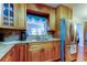 Bright kitchen with wood cabinetry, granite counters, stainless steel appliances, and an open flow at 2800 54Th N St, St Petersburg, FL 33710
