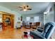 Open-concept living room with a ceiling fan, wood floors, and comfortable seating at 2800 54Th N St, St Petersburg, FL 33710
