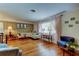 Bright living room with hardwood floors, large windows with pink curtains, and classic decor at 2800 54Th N St, St Petersburg, FL 33710