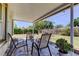 Covered patio with stone flooring and outdoor seating provides a relaxing space overlooking the landscaped yard at 2800 54Th N St, St Petersburg, FL 33710