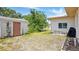 Exterior view of a spacious backyard with a shed and the house at 2810 9Th St, Englewood, FL 34224