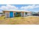 Charming single-story home featuring a light exterior, bright blue shutters, and well-maintained landscaping at 2810 9Th St, Englewood, FL 34224
