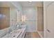 Bright bathroom featuring double sinks with marble countertops and modern lighting at 3012 W Barcelona St # 7, Tampa, FL 33629
