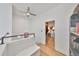 Bright hallway with natural light, wooden floors, and a peek into a bedroom or dressing area at 3012 W Barcelona St # 7, Tampa, FL 33629